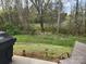 Scenic backyard view with lush greenery, overlooking trees, and outdoor seating area at 14022 Clayborn St, Midland, NC 28107