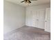 Spacious bedroom features neutral carpet, a ceiling fan, and a closet with full length doors at 14022 Clayborn St, Midland, NC 28107
