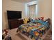 Bright bedroom featuring a television, a colorful comforter, and a cheerful Pokemon themed design at 14022 Clayborn St, Midland, NC 28107