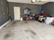 Spacious gray garage featuring painted walls, concrete floors, and ample storage shelving at 14022 Clayborn St, Midland, NC 28107