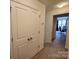 Hallway with linen closet, leading to a home office with a desk and a great window view at 14022 Clayborn St, Midland, NC 28107