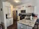Modern kitchen featuring granite countertops, stainless steel appliances, and white cabinets at 14022 Clayborn St, Midland, NC 28107