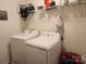 A laundry room with white washer and dryer, wire shelving, and other storage options at 14022 Clayborn St, Midland, NC 28107