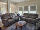 Inviting living room featuring cozy gray sofas, coffee table, and abundant natural light at 14022 Clayborn St, Midland, NC 28107