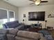 Relaxing living room with comfortable gray couches, television, and a ceiling fan at 14022 Clayborn St, Midland, NC 28107