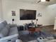 Spacious living room featuring television, speakers, artwork, and wood flooring at 14022 Clayborn St, Midland, NC 28107