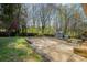 Backyard patio with stone pavers, green grass, and privacy fence at 1421 Sherwood Dr, Kannapolis, NC 28081