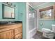 Bathroom with wooden vanity, glass door shower, and tile floors at 1421 Sherwood Dr, Kannapolis, NC 28081