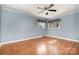 Bright bedroom features hardwood floors, ceiling fan and fresh blue paint at 1421 Sherwood Dr, Kannapolis, NC 28081