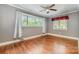 Bedroom with hardwood floors, ceiling fan, and large window overlooking the backyard at 1421 Sherwood Dr, Kannapolis, NC 28081