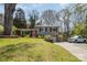 Split-level home with a brick and siding exterior, front lawn and long driveway at 1421 Sherwood Dr, Kannapolis, NC 28081