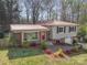 Charming home with brick and siding, complemented by a lush, landscaped front yard at 1421 Sherwood Dr, Kannapolis, NC 28081