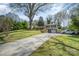 Charming split-level home with a long driveway, mature tree, and well-manicured lawn at 1421 Sherwood Dr, Kannapolis, NC 28081