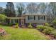 Split-level home with a brick and siding exterior, front lawn and small garden at 1421 Sherwood Dr, Kannapolis, NC 28081