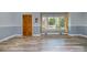 Living room featuring neutral wall colors, updated flooring, and a large window at 1421 Sherwood Dr, Kannapolis, NC 28081