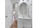Modern half bathroom featuring a vanity with a sleek, rounded mirror at 14256 Drake Watch Ln, Charlotte, NC 28262