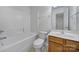 Bathroom featuring a tub, toilet, and a single sink vanity at 14256 Drake Watch Ln, Charlotte, NC 28262