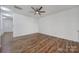 A bright, spacious bedroom featuring wood-look floors and a modern ceiling fan at 14256 Drake Watch Ln, Charlotte, NC 28262