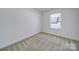 Bedroom with carpeted floors and a window providing natural light at 14256 Drake Watch Ln, Charlotte, NC 28262