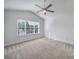 Bright bedroom featuring a vaulted ceiling, ceiling fan, and a large window at 14256 Drake Watch Ln, Charlotte, NC 28262