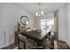 Elegant dining room with dark wood table, modern chandelier, and stylish decor at 14256 Drake Watch Ln, Charlotte, NC 28262