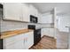 Kitchen area with white cabinets, wood countertops, and stainless steel appliances at 14256 Drake Watch Ln, Charlotte, NC 28262