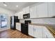 Well-lit kitchen with white cabinets, wood countertops, and stainless steel appliances at 14256 Drake Watch Ln, Charlotte, NC 28262