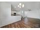 Open living room with wood floors, chair rail, and abundant natural light at 14256 Drake Watch Ln, Charlotte, NC 28262