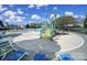 Community pool and splash area with lounge chairs at 14256 Drake Watch Ln, Charlotte, NC 28262