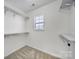 Walk-in closet with shelving and a window provides ample storage space at 14256 Drake Watch Ln, Charlotte, NC 28262