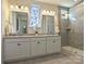 Bright bathroom featuring a double vanity, decorative window, and walk-in shower with glass door at 152 Amerson Dr, Rock Hill, SC 29730