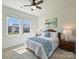 Cozy bedroom with natural light, ceiling fan, and carpet flooring, complemented by warm, neutral walls at 152 Amerson Dr, Rock Hill, SC 29730