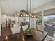 Dining room with modern chandelier, table with six chairs, and sliding glass door to the outdoor patio at 152 Amerson Dr, Rock Hill, SC 29730