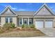 Charming brick home featuring a two-car garage, well-kept landscaping, and a welcoming front porch at 152 Amerson Dr, Rock Hill, SC 29730