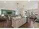 Open-concept kitchen with granite island and seating flows into the living and dining areas, creating an inclusive space at 152 Amerson Dr, Rock Hill, SC 29730