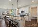 Open concept kitchen features a granite island with seating and is adjacent to the dining area and living room at 152 Amerson Dr, Rock Hill, SC 29730