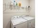 Functional laundry room equipped with a washer, dryer, and shelving for optimal storage solutions at 152 Amerson Dr, Rock Hill, SC 29730