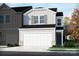 Charming two-story home with white garage door and front yard landscaping at 1713 Braemar Village Dr, Monroe, NC 28110