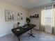 Bright home office with a modern desk, stylish decor, and natural light at 1713 Braemar Village Dr, Monroe, NC 28110