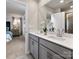 Bathroom featuring double vanity sinks, gray cabinets, and a view into the bedroom at 1716 Braemar Village Dr, Monroe, NC 28110