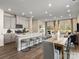 The modern open-concept kitchen leads into the dining and living areas, perfect for entertaining guests at 1716 Braemar Village Dr, Monroe, NC 28110