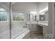 Bathroom offers a soaking tub, a large window, and a vanity with extra makeup space at 17301 Glassfield Dr, Huntersville, NC 28078
