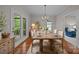 Sunlit dining room with hardwood floors and seating for six at 17301 Glassfield Dr, Huntersville, NC 28078