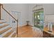 Inviting foyer featuring hardwood floors, staircase, and view into the naturally lit front yard at 17301 Glassfield Dr, Huntersville, NC 28078