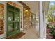 Inviting front porch featuring stone accents, rocking chairs, and a bright green front door at 17301 Glassfield Dr, Huntersville, NC 28078