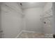 Small laundry room showcasing metal shelving, tile flooring, and off-white walls at 17301 Glassfield Dr, Huntersville, NC 28078