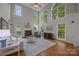 Bright living room with soaring ceilings, large windows, fireplace, and hardwood floors at 17301 Glassfield Dr, Huntersville, NC 28078