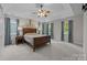 Spacious bedroom features a tray ceiling, ceiling fan, three large windows, and neutral-colored walls and carpet at 17301 Glassfield Dr, Huntersville, NC 28078