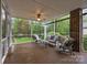 Relaxing screened porch with comfortable seating and a ceiling fan to enjoy the wooded back yard at 17301 Glassfield Dr, Huntersville, NC 28078