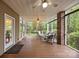 Relaxing screened porch with comfortable seating and a ceiling fan to enjoy the wooded back yard at 17301 Glassfield Dr, Huntersville, NC 28078